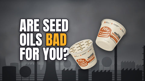 Are seed oils bad for you? Beef Cakes protein pancake cups in front of a chemical plant under a gray sky
